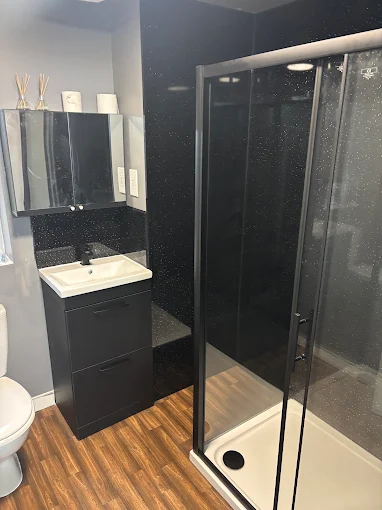 Black sparkle shower room installed by Aburrow Property Services